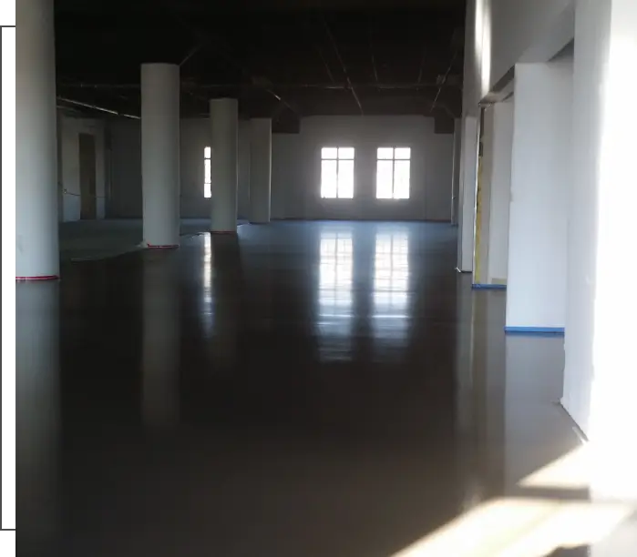 Empty room with polished concrete floor.