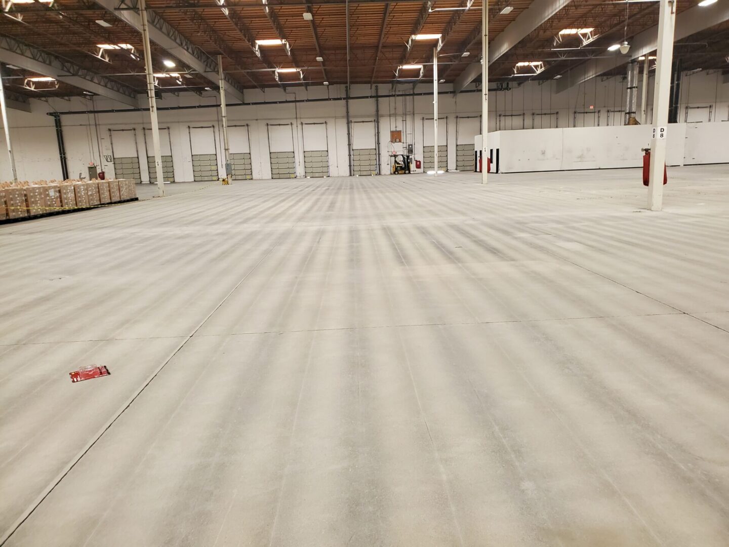 Empty warehouse with concrete floor.